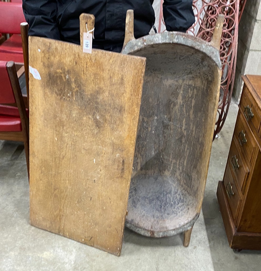 A chip carved grain trough, length 104cm and a provincial wood board, length 102cm